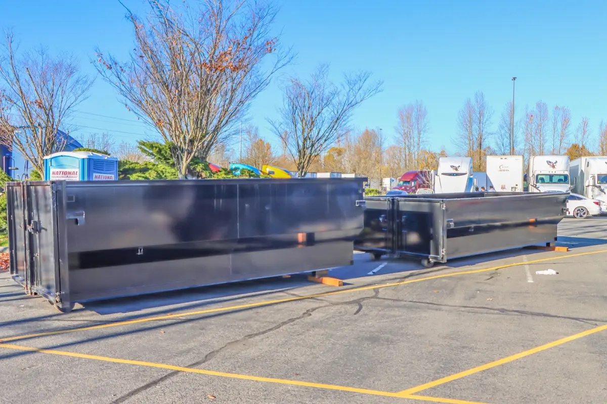 Professional dumpster rental service with roll-off container on residential driveway in Hooper